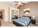 Comfortable bedroom featuring a ceiling fan, mirrored closet, and stylish decor at 301 E Ashurst Dr, Phoenix, AZ 85048