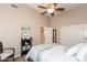 Bedroom with ceiling fan, neutral walls, and a closet with sliding doors at 301 E Ashurst Dr, Phoenix, AZ 85048