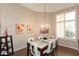 Dining room features a chandelier, tile and wood flooring, lots of natural light, and neutral walls at 301 E Ashurst Dr, Phoenix, AZ 85048