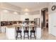 Well-lit kitchen with modern appliances, an island with bar stools, and ample counter space at 301 E Ashurst Dr, Phoenix, AZ 85048