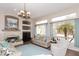 Inviting living room featuring a stone fireplace, plush seating, and ample natural light at 301 E Ashurst Dr, Phoenix, AZ 85048