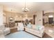 Open-concept living room with sofas, chairs, and connection to the kitchen and dining area at 301 E Ashurst Dr, Phoenix, AZ 85048