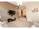 Open-concept living room with a TV, recessed lights, carpet and neutral tones, and archways to other rooms at 301 E Ashurst Dr, Phoenix, AZ 85048