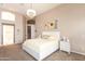 Bright main bedroom with neutral walls, plush carpet, and stylish chandelier at 301 E Ashurst Dr, Phoenix, AZ 85048