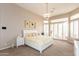 Spacious main bedroom with chandelier and large windows offering natural light at 301 E Ashurst Dr, Phoenix, AZ 85048