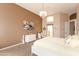 Inviting main bedroom featuring warm wall colors and elegant chandelier lighting at 301 E Ashurst Dr, Phoenix, AZ 85048