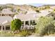 Expansive rear exterior view of home showcasing a covered patio, grill, and desert landscaping at 301 E Ashurst Dr, Phoenix, AZ 85048