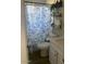 Bathroom showcasing a toilet, sink, and floral shower curtain at 3431 W Campbell Ave, Phoenix, AZ 85017