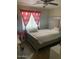 Bedroom featuring a bed, window with curtains, and wood floors at 3431 W Campbell Ave, Phoenix, AZ 85017