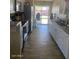 Bright kitchen featuring white cabinets and wood floors, with access to the backyard at 3431 W Campbell Ave, Phoenix, AZ 85017