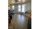 Comfortable living room with wood floors, bright windows, and a ceiling fan at 3431 W Campbell Ave, Phoenix, AZ 85017