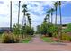 Inviting brick walkway adorned with lush greenery, palm trees, and seating, creating a tranquil outdoor space at 3431 W Campbell Ave, Phoenix, AZ 85017