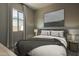 Comfortable bedroom featuring a queen-size bed, soft lighting, and a modern art piece on the wall at 37765 W Santa Maria St, Maricopa, AZ 85138