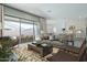 Spacious living room with a view to the patio and kitchen featuring modern furnishings and decor at 37765 W Santa Maria St, Maricopa, AZ 85138