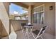 Cozy balcony with small table set and partial views of the home's exterior at 3830 E Lakewood Pkwy # 3164, Phoenix, AZ 85048