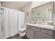 Bright bathroom featuring a shower with curtain, a vanity and decorative mirror at 3830 E Lakewood Pkwy # 3164, Phoenix, AZ 85048