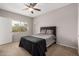 This bedroom has neutral colors, a ceiling fan, and a window offering natural light at 3830 E Lakewood Pkwy # 3164, Phoenix, AZ 85048