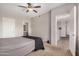 Bedroom with neutral colors, ceiling fan, and doors leading into the bathroom and hallway at 3830 E Lakewood Pkwy # 3164, Phoenix, AZ 85048