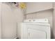 Laundry room with a white washer and dryer under shelving for extra storage at 3830 E Lakewood Pkwy # 3164, Phoenix, AZ 85048