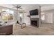 Living room featuring a fireplace, a ceiling fan, and an exterior balcony at 3830 E Lakewood Pkwy # 3164, Phoenix, AZ 85048