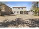 Backyard with a plain dirt lawn with paver patios surrounded by block wall fencing at 3911 S 100Th Gln, Tolleson, AZ 85353