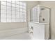 Bright bathroom featuring a glass-enclosed shower and frosted glass block window over a soaking tub at 3911 S 100Th Gln, Tolleson, AZ 85353