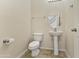 Powder room featuring a pedestal sink, tiled floors, and neutral wall color at 3911 S 100Th Gln, Tolleson, AZ 85353