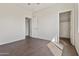 Bedroom with neutral walls, wood-look floors, a ceiling fan, and a closet at 3911 S 100Th Gln, Tolleson, AZ 85353