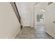 Entryway view with stairs, tile flooring, and views of the open living space and the home's front door at 3911 S 100Th Gln, Tolleson, AZ 85353