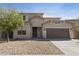 Inviting two-story home with a well-maintained facade, desert landscaping, and an attached two-car garage at 3911 S 100Th Gln, Tolleson, AZ 85353