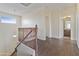 Hallway at the top of the stairs, with wooden railing, leading to bathroom and other rooms at 3911 S 100Th Gln, Tolleson, AZ 85353