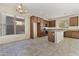 Spacious kitchen with tile flooring, center island, granite countertops, and dark wood cabinetry at 3911 S 100Th Gln, Tolleson, AZ 85353