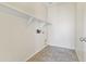 Laundry room with tiled floor, utility connections, and shelving at 3911 S 100Th Gln, Tolleson, AZ 85353