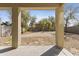 Covered patio area with an expansive view of the backyard and simple landscaping at 3911 S 100Th Gln, Tolleson, AZ 85353