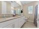 Bright bathroom featuring a double sink vanity and framed mirror at 4077 S Sabrina Dr # 23, Chandler, AZ 85248