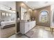 Bathroom featuring a dual sink vanity with white cabinets and an arch window with natural light at 4077 S Sabrina Dr # 23, Chandler, AZ 85248