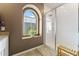 Bright bathroom featuring a glass-enclosed shower, a sunny arched window, and tile flooring at 4077 S Sabrina Dr # 23, Chandler, AZ 85248