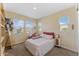 Bright bedroom with floral bedding, complemented by natural light streaming through the large window at 4077 S Sabrina Dr # 23, Chandler, AZ 85248