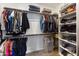 Organized walk-in closet with ample hanging space, shelving, and overhead storage for suitcases at 4077 S Sabrina Dr # 23, Chandler, AZ 85248