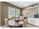 Bright dining area featuring a round wood table, upholstered chairs, and decorative shelving at 4077 S Sabrina Dr # 23, Chandler, AZ 85248