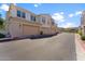 Street view of the condo with individual garages and desert landscaping at 4077 S Sabrina Dr # 23, Chandler, AZ 85248