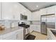 Bright kitchen featuring stainless steel appliances, white cabinets, light countertops and subway tile backsplash at 4077 S Sabrina Dr # 23, Chandler, AZ 85248