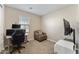 Carpeted home office with chair, dual monitors, printer, and a large window for natural light at 4077 S Sabrina Dr # 23, Chandler, AZ 85248