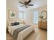Serene bedroom with neutral decor, a ceiling fan, large windows, and a dresser with a mirror at 4354 N 82Nd St # 182, Scottsdale, AZ 85251