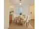 Cozy dining area with round wooden table, three chairs, and a bright window with blinds at 4354 N 82Nd St # 182, Scottsdale, AZ 85251