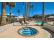 Relaxing jacuzzi with sparkling blue tiles, surrounded by tropical palm trees under a clear blue sky at 4354 N 82Nd St # 182, Scottsdale, AZ 85251