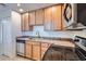 Close-up of the kitchen featuring stainless steel appliances and tan cabinetry at 4354 N 82Nd St # 182, Scottsdale, AZ 85251