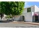 Charming white stucco home with a wrought iron gate and mature landscaping creating curb appeal at 4825 N 72Nd Way, Scottsdale, AZ 85251