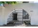 Elegant wrought iron gate provides entry to a white-walled property with house number 4825 displayed above at 4825 N 72Nd Way, Scottsdale, AZ 85251