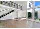 Bright open living room with a modern staircase, clerestory windows, and neutral décor at 4825 N 72Nd Way, Scottsdale, AZ 85251